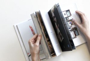 person flicking through magazine